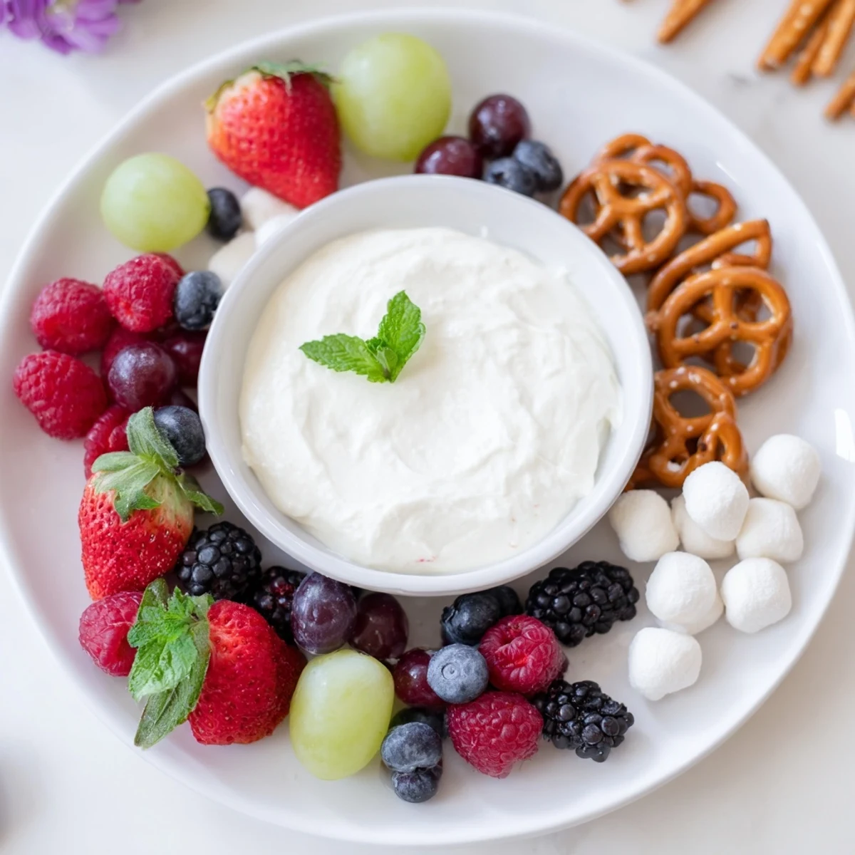 Bright red strawberries and fresh blueberries enhance this beautiful Mistletoe Kiss Berry Dip Board, a delightful dessert.
