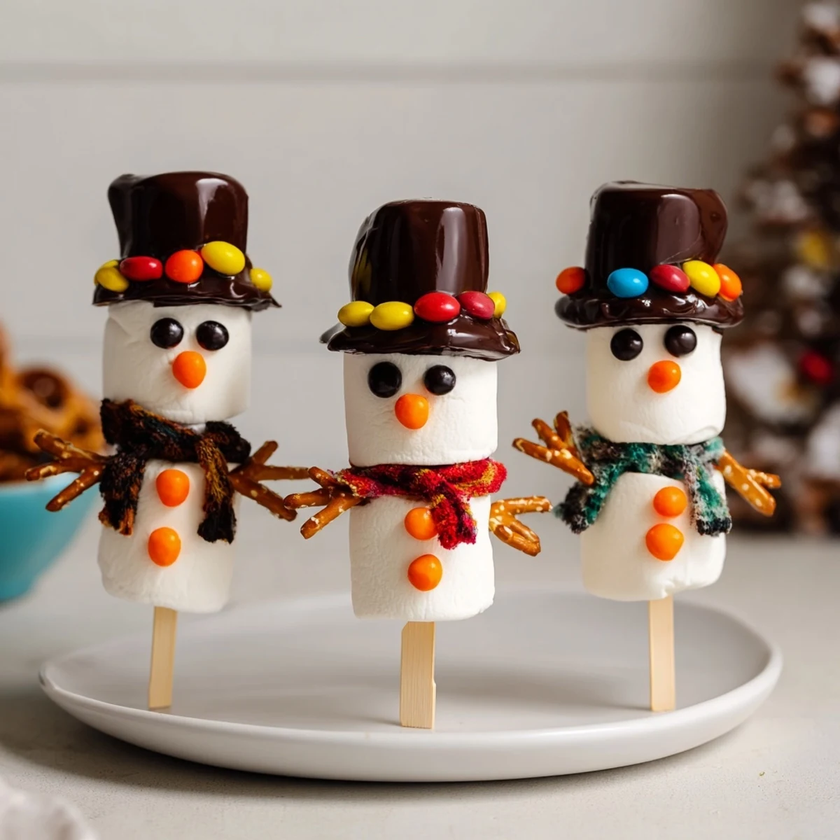 These easy-to-make marshmallow snowman stick arrangements feature pretzel arms, perfect winter snacks.