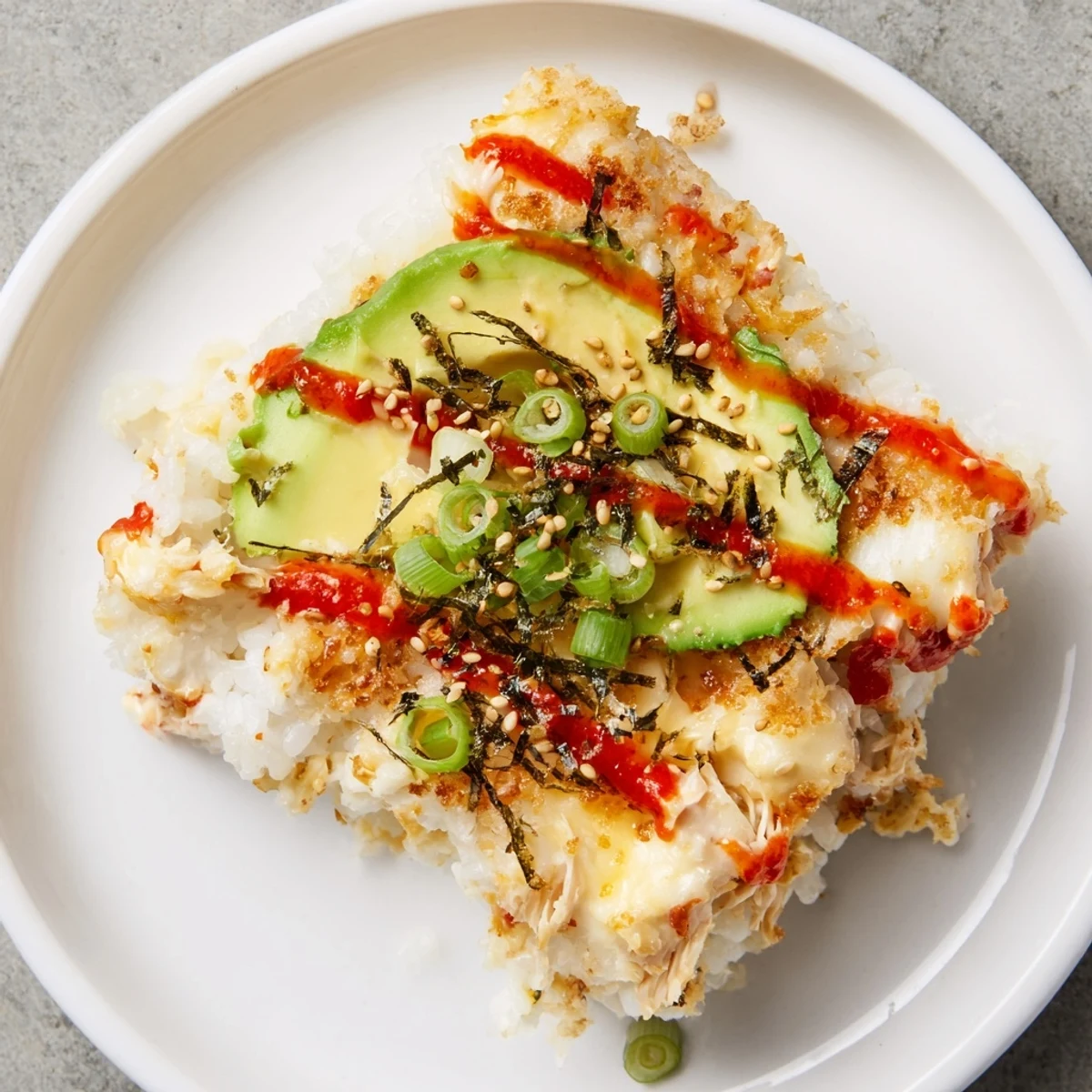 Delicious and comforting, this Chicken Sushi Bake features a flavorful creamy chicken topping.