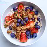 A close-up of overnight oats gourmet makeover, showcasing cookie crumbles and a nut butter swirl.