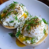 A bright photo of perfectly poached eggs atop yogurt, creating delicious çılbır Eggs Benedict.
