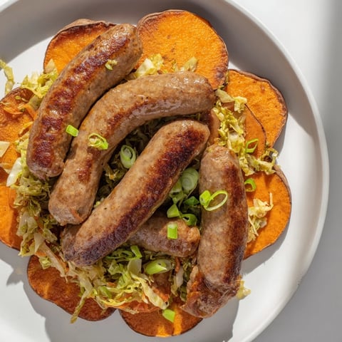 Golden-brown Baked Sweet Potato Bratwursts with a vibrant sauerkraut slaw, ready to eat.