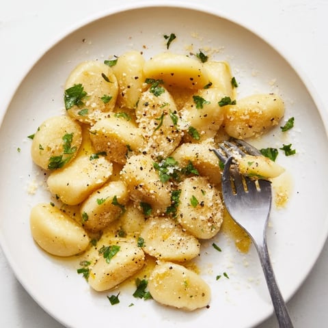 Golden-brown potato dumplings swimming in a rich Parmesan-garlic brown butter sauce; comfort food!