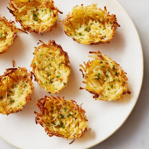 Golden-brown, crispy potato rösti boats, ready to be filled with delicious toppings for brunch.