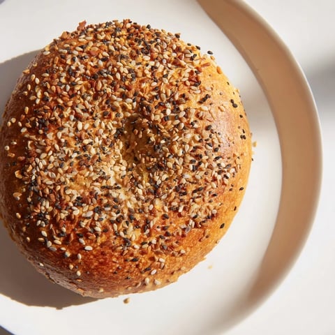 Golden brown everything bagel yogurt bagels, sprinkled with savory seasoning, fresh from the oven.