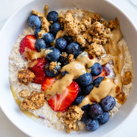 Creamy overnight oats gourmet makeover, swirled with peanut butter and topped with fresh berries.