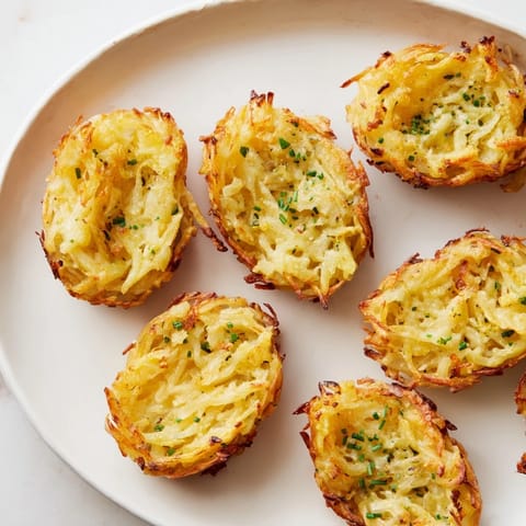 A close-up of a perfectly formed crispy potato rösti boat, cooked until golden and delicious.