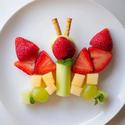 This butterfly-shaped Butterfly Fruit Tray features a selection of fresh, colorful fruits ready to enjoy.