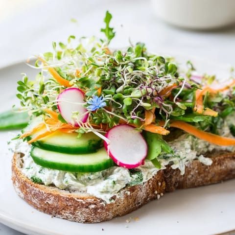 A hearty Green Goddess sandwich, with layers of colorful vegetables, ready to eat.