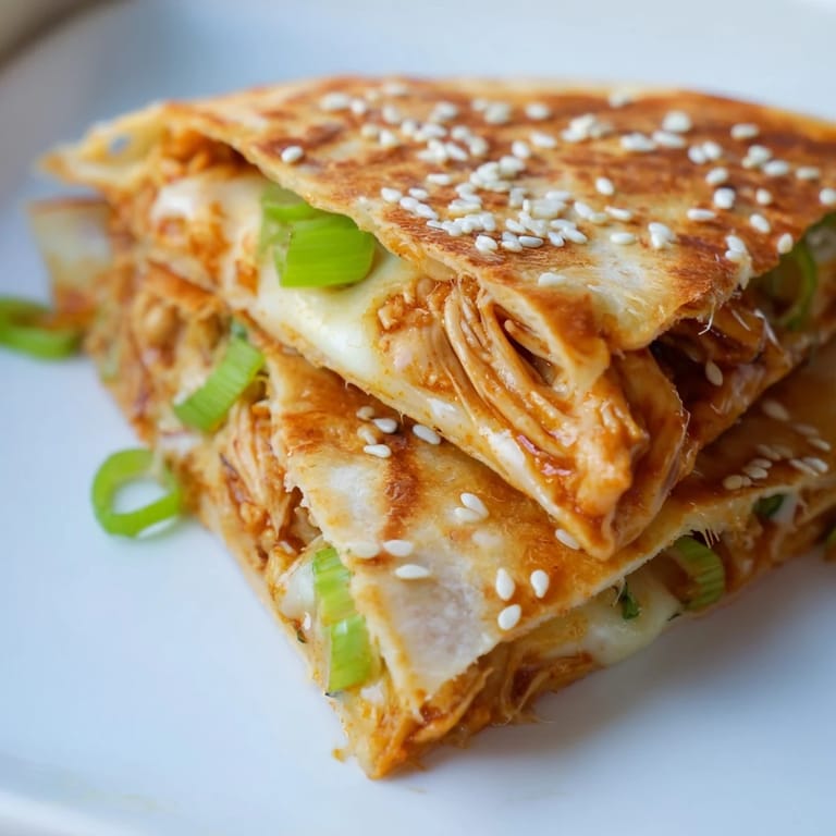 Golden, crispy Korean BBQ chicken wrap grilled cheese, featuring melted cheese and sesame seeds.