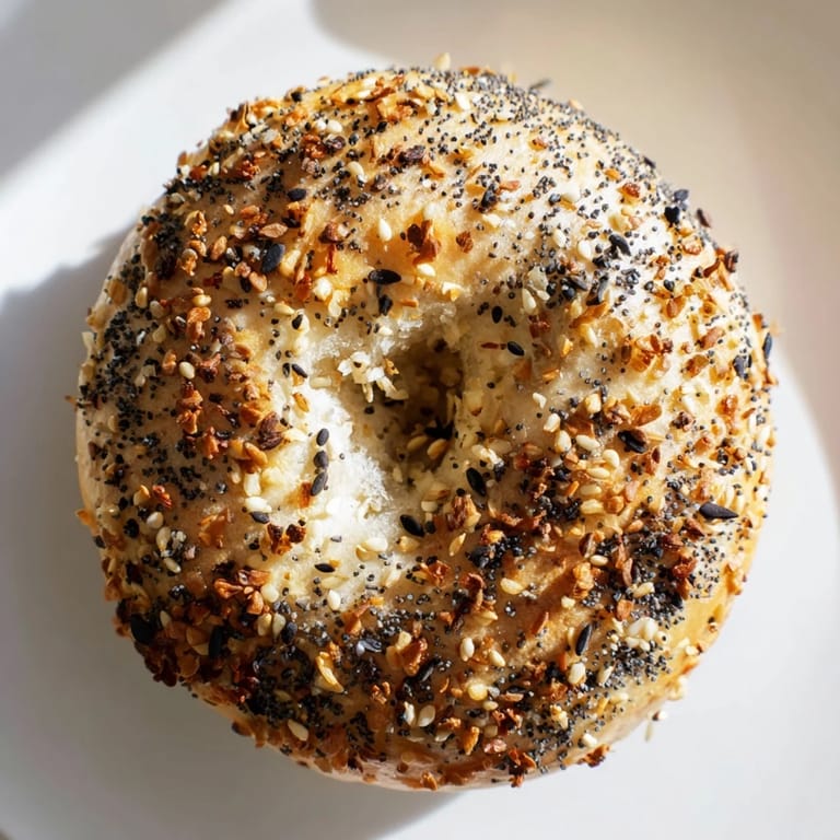 A close-up of a perfectly baked everything bagel yogurt bagel, ideal for breakfast or brunch.